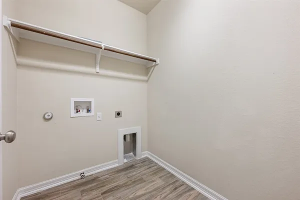 a view of room with wooden floor