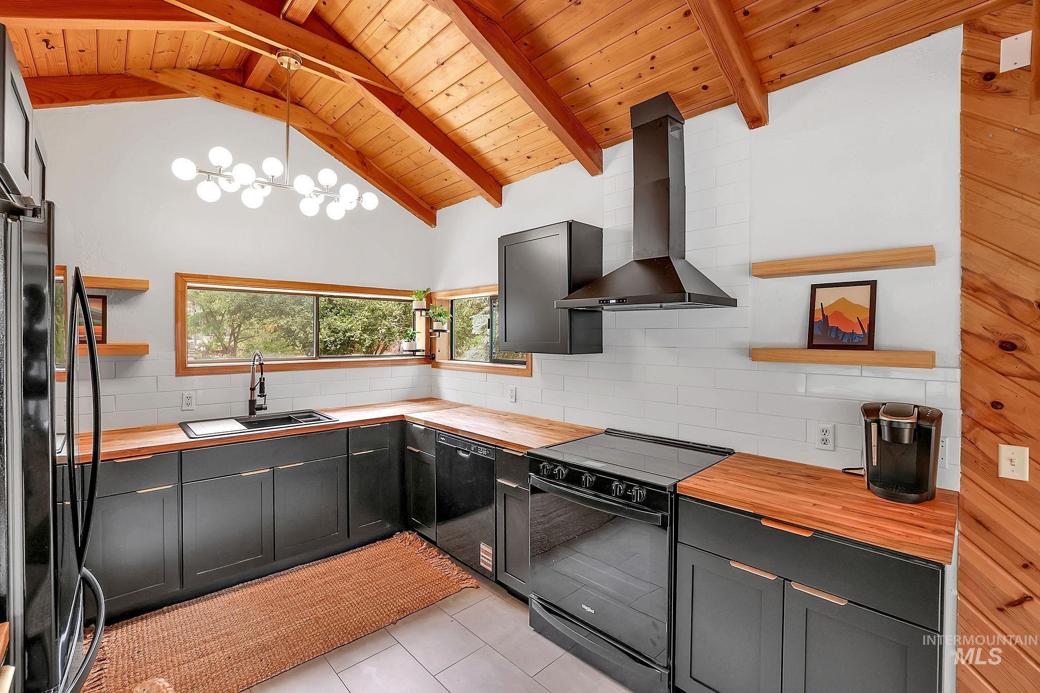 5713 Pines Road New Meadows, ID 83654 - Photo 12 of 45 Kitchen with open shelves, wooden counters, black appliances, wooden ceiling, and backsplash