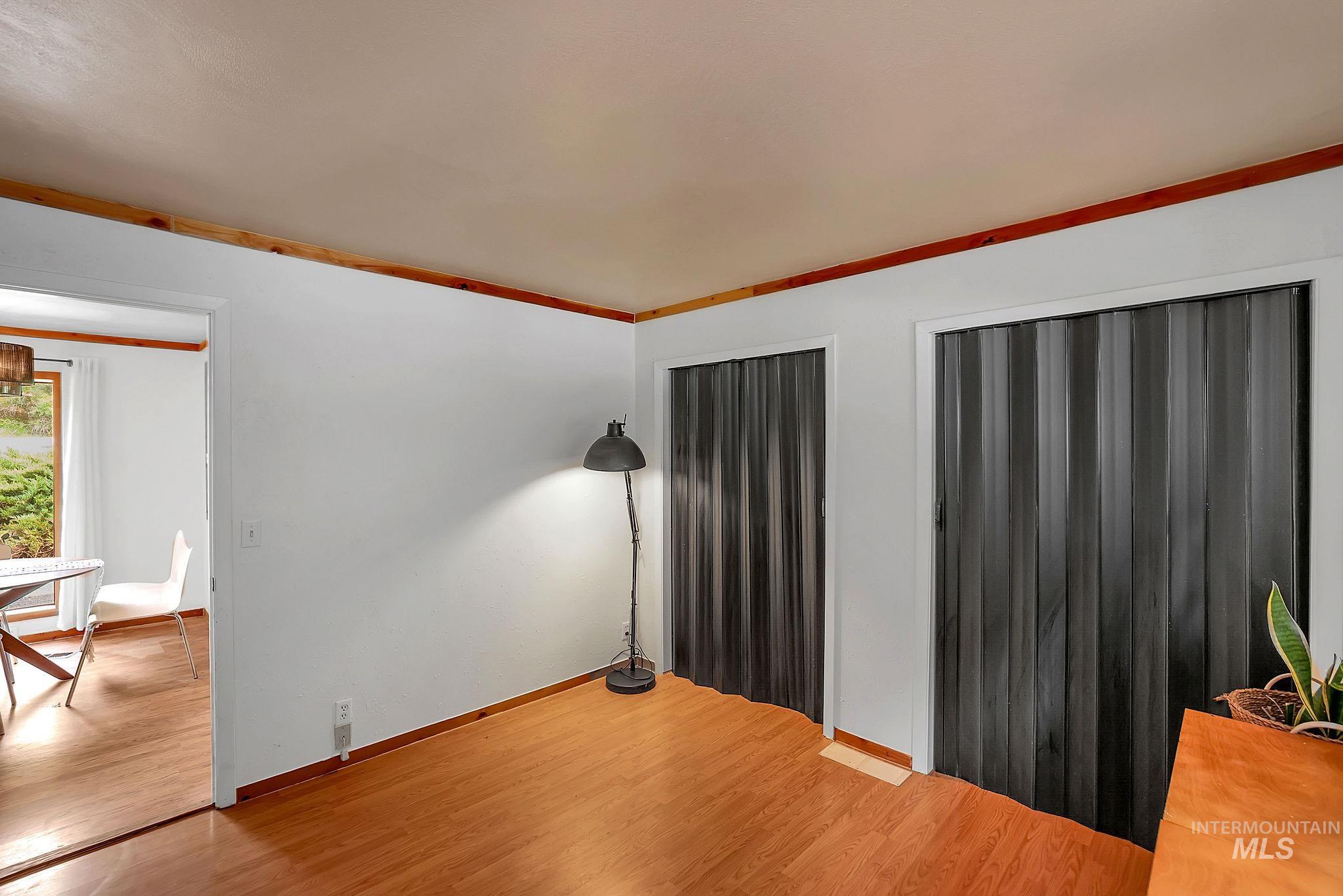 5713 Pines Road New Meadows, ID 83654 - Photo 23 of 45 Unfurnished living room featuring light wood-type flooring and crown molding