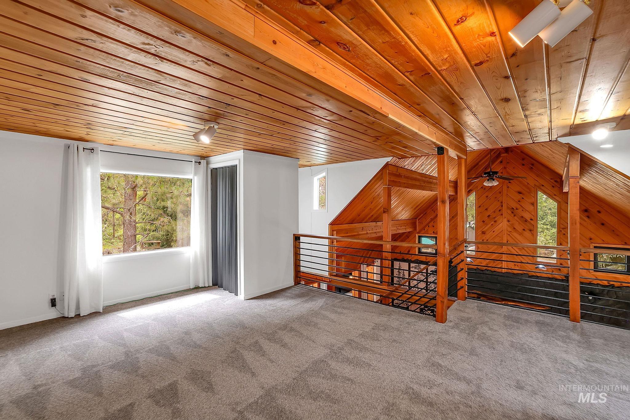 5713 Pines Road New Meadows, ID 83654 - Photo 27 of 45 Unfurnished bedroom with wooden ceiling, wooden walls, and carpet flooring