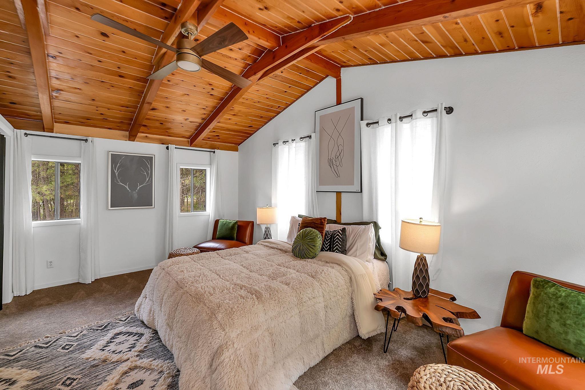 5713 Pines Road New Meadows, ID 83654 - Photo 30 of 45 Carpeted bedroom featuring wooden ceiling, multiple windows, and vaulted ceiling with beams