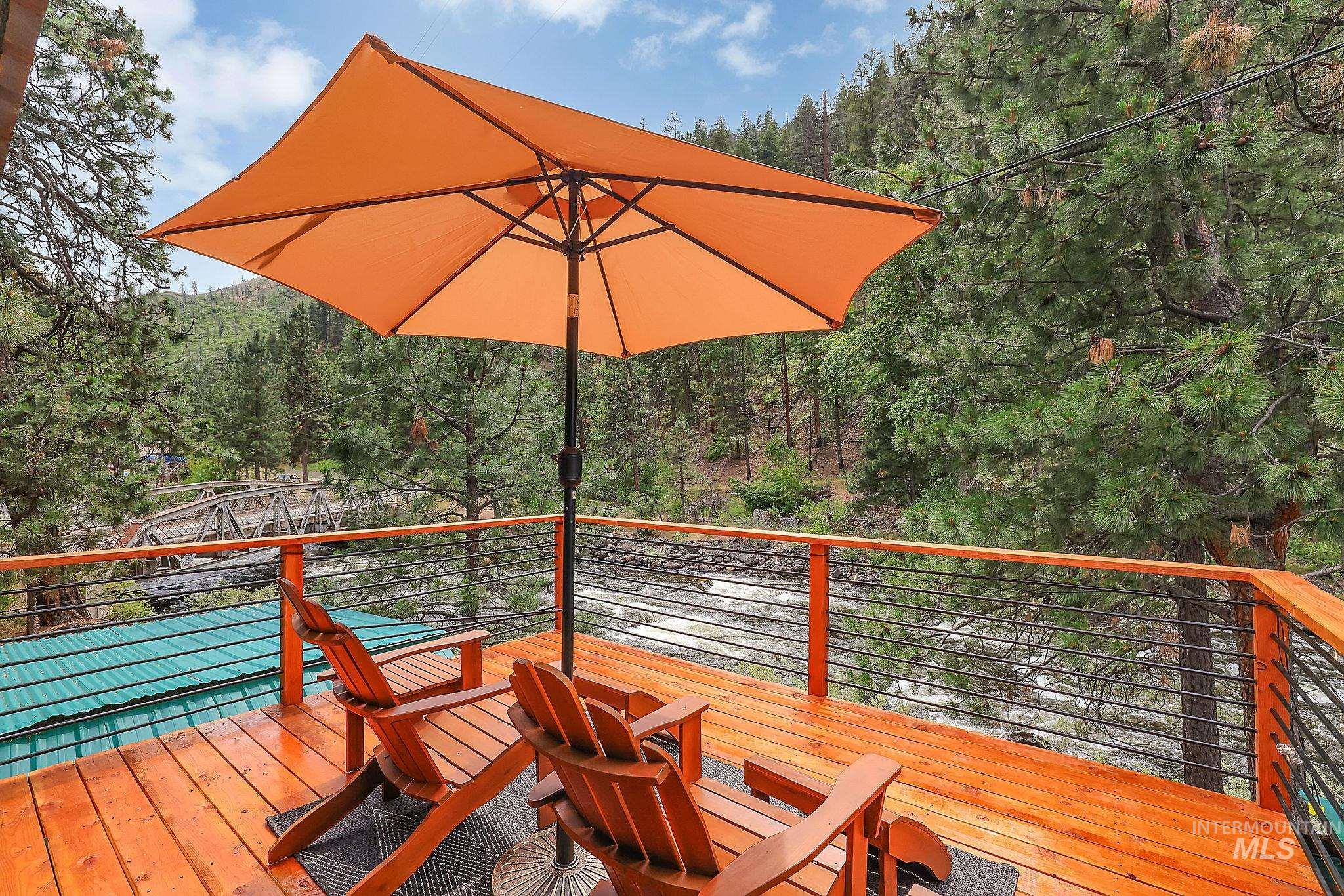 5713 Pines Road New Meadows, ID 83654 - Photo 33 of 45 Wooden deck with a forest view