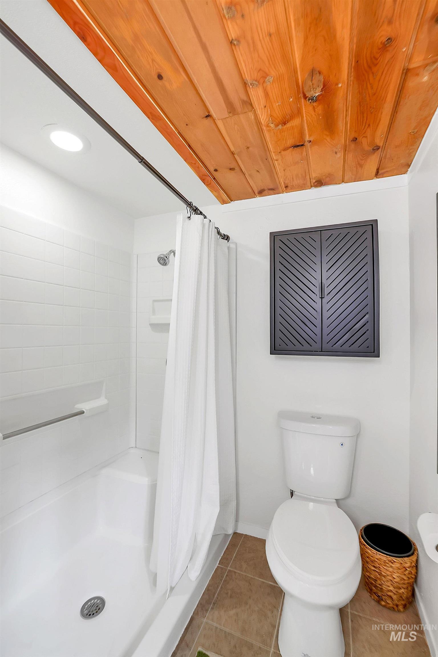 5713 Pines Road New Meadows, ID 83654 - Photo 35 of 45 Full bath with a shower stall, light tile patterned floors, and wood ceiling