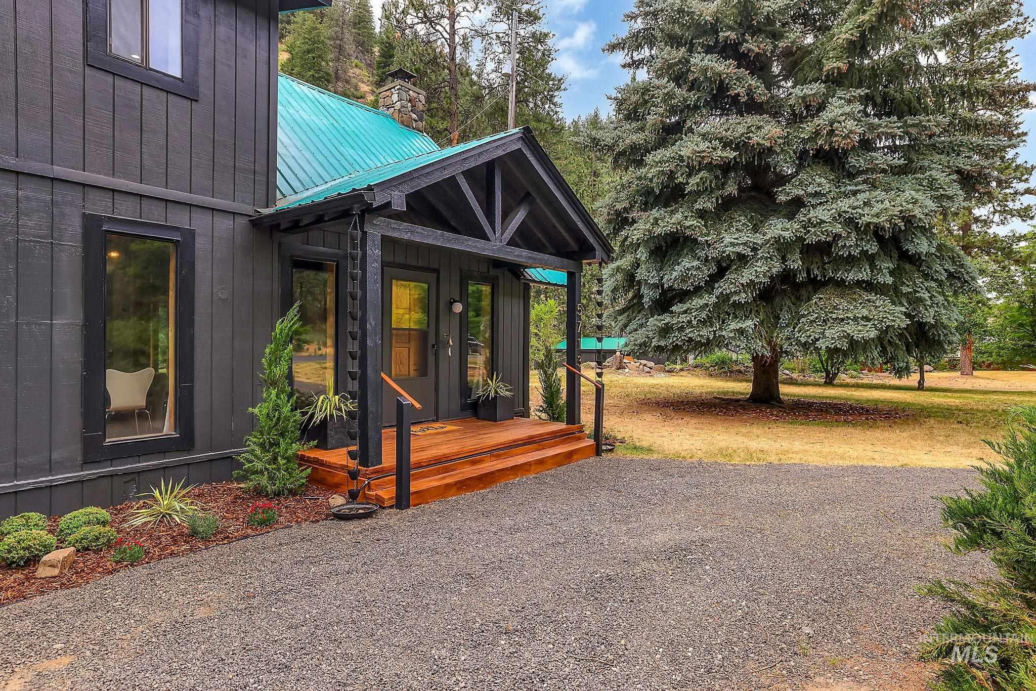 5713 Pines Road New Meadows, ID 83654 - Photo 6 of 45 Doorway to property featuring a metal roof, a chimney, and a porch