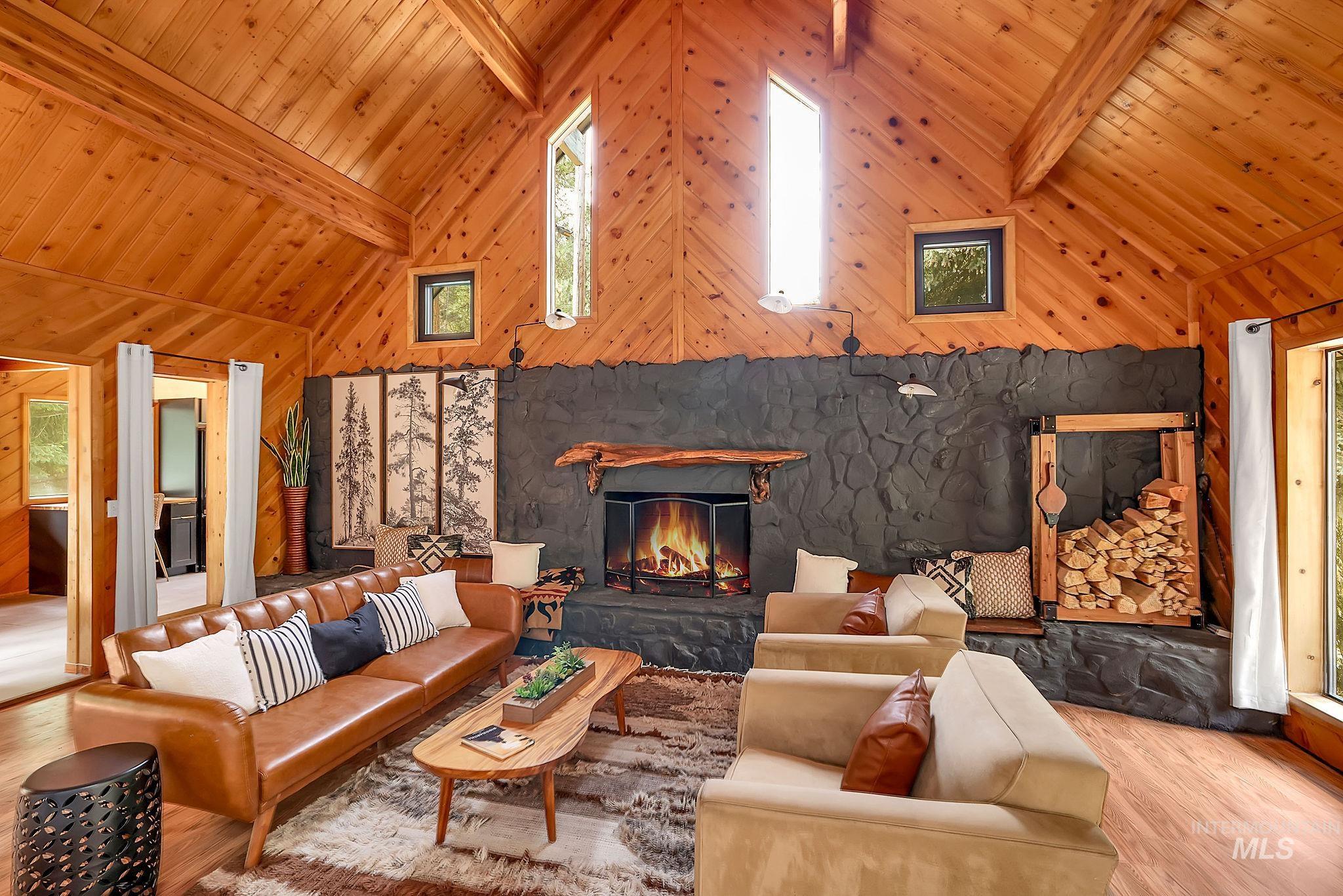 5713 Pines Road New Meadows, ID 83654 - Photo 10 of 45 Living area with wood finished floors, lofted ceiling, and a stone fireplace