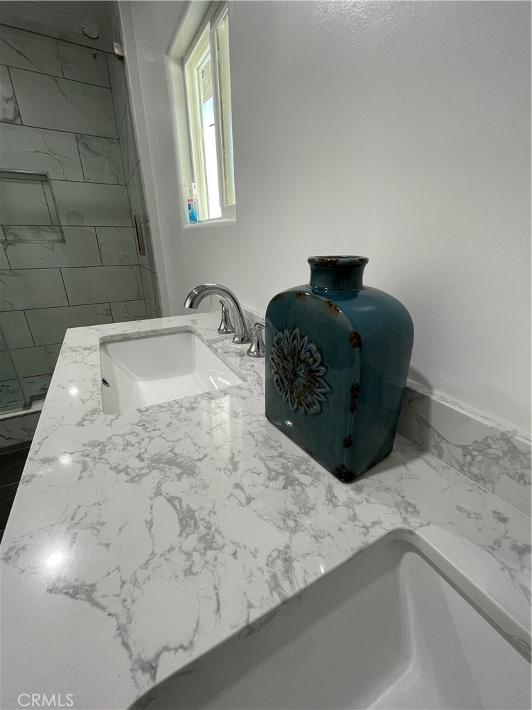 3745 Valley Boulevard Walnut, CA 91789 - Photo 5 of 10 a bathroom with a granite countertop sink a toilet and mirror