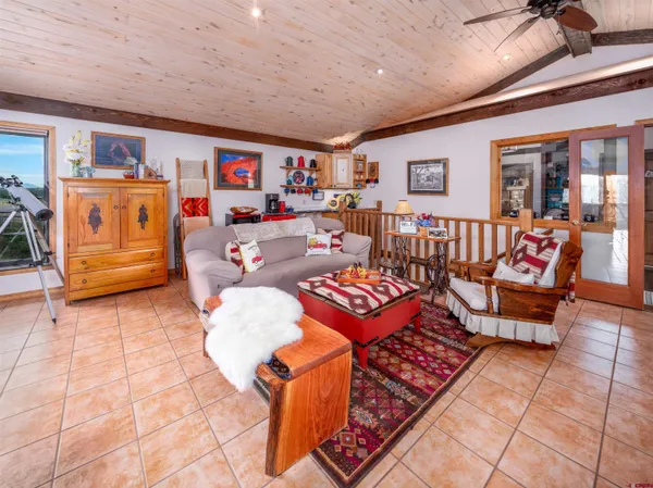 a living room with lots of furniture and a chandelier