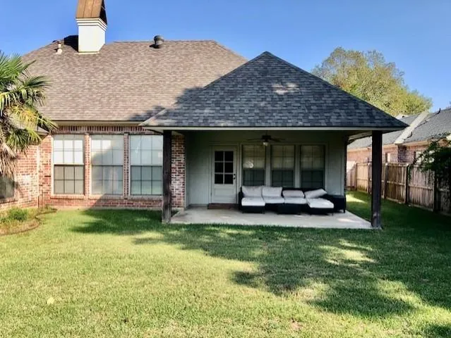 a view of a house with backyard porch and sitting area