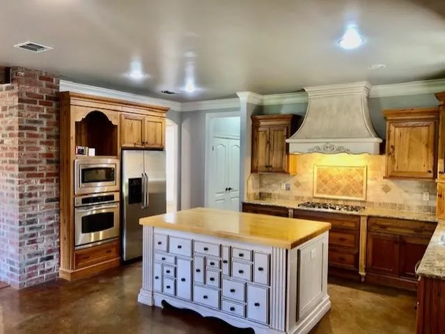 a kitchen with stainless steel appliances a stove and a refrigerator