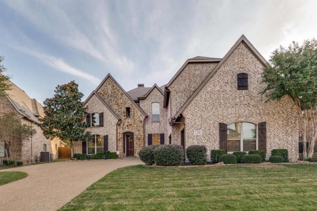 2810 Baker Street Sachse, TX 75048 - Photo 2 of 26 French country inspired facade with brick siding, a front yard, and stone siding