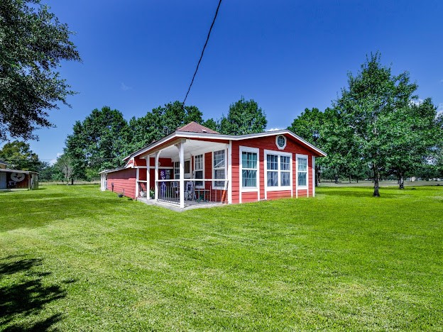 13025 Battle Road Beasley, TX 77417 - Photo 5 of 13 a view of a house with a big yard