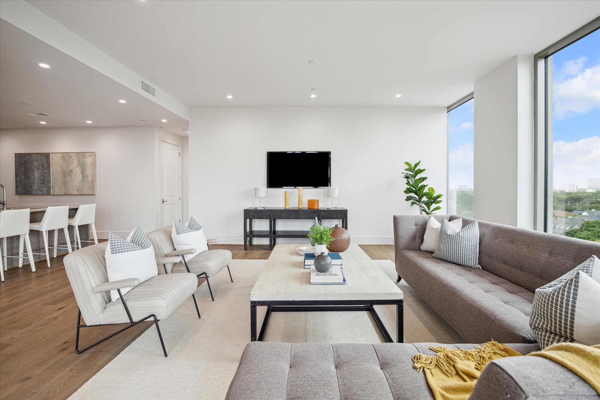 5656 San Felipe Street, Unit 701 Houston, TX 77056 - Photo 42 of 44 Alternate living space layout highlighting the open floor plan tailored for entertaining. Photo is of a similar unit with the same floor plan.