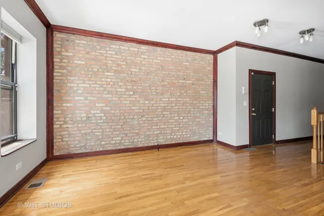 a view of an empty room with brick walls