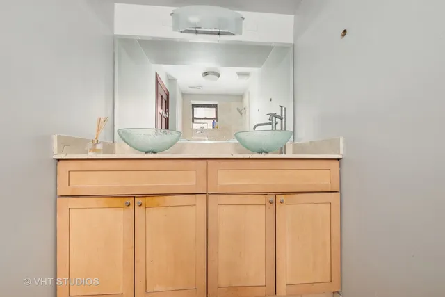 a bathroom with a granite countertop sink and a mirror