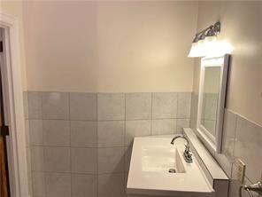 92 West Main Street, Unit 210 Uniontown, PA 15401 - Photo 12 of 13 a bathroom with a sink a vanity and mirror