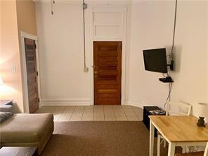 92 West Main Street, Unit 210 Uniontown, PA 15401 - Photo 8 of 13 a living room with furniture and a flat screen tv