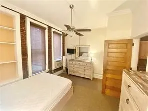 a bedroom with a bed and ceiling fan