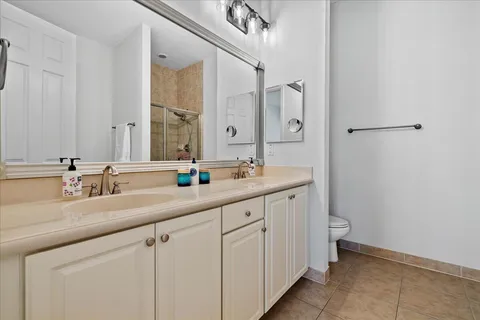 a bathroom with a double vanity sink and a mirror