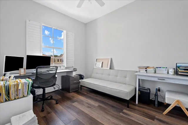 a view of a livingroom with workspace and a couch