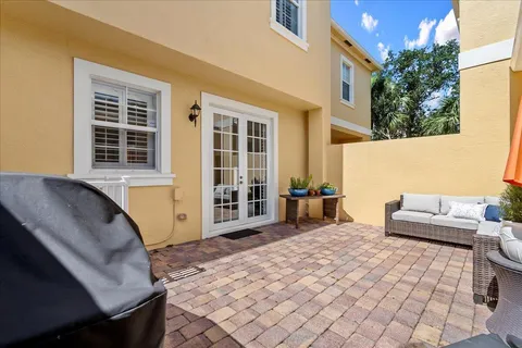 a view of a house with backyard and sitting area