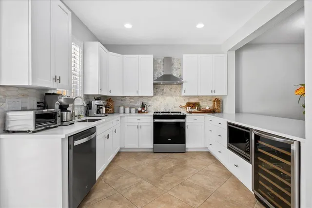 a kitchen with stainless steel appliances granite countertop a stove sink and cabinets