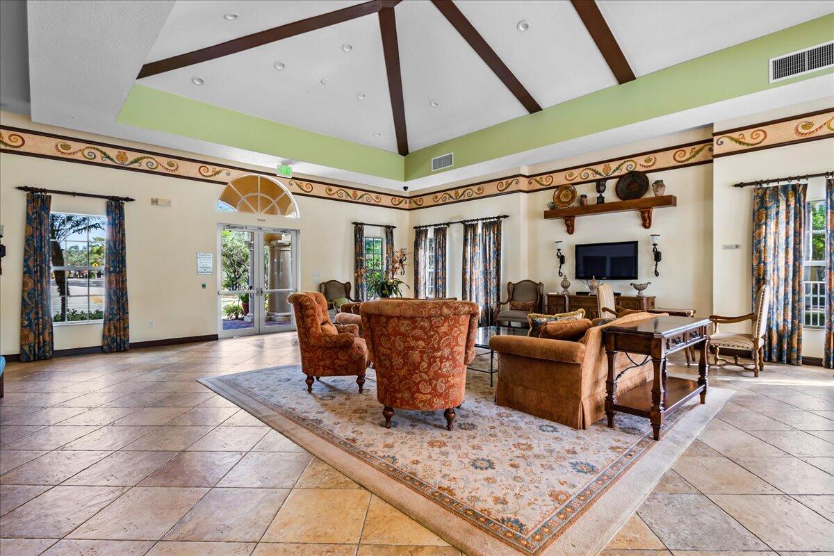 251 Edenberry Avenue Jupiter, FL 33458 - Photo 27 of 31 a living room with furniture a window and a table