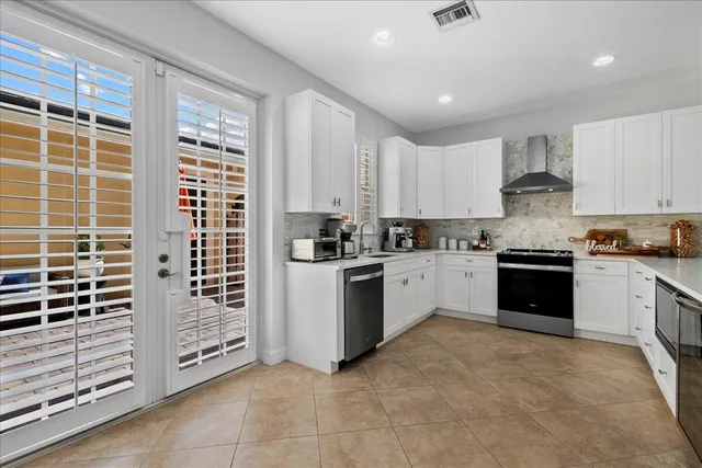 a kitchen with granite countertop a stove sink and cabinets