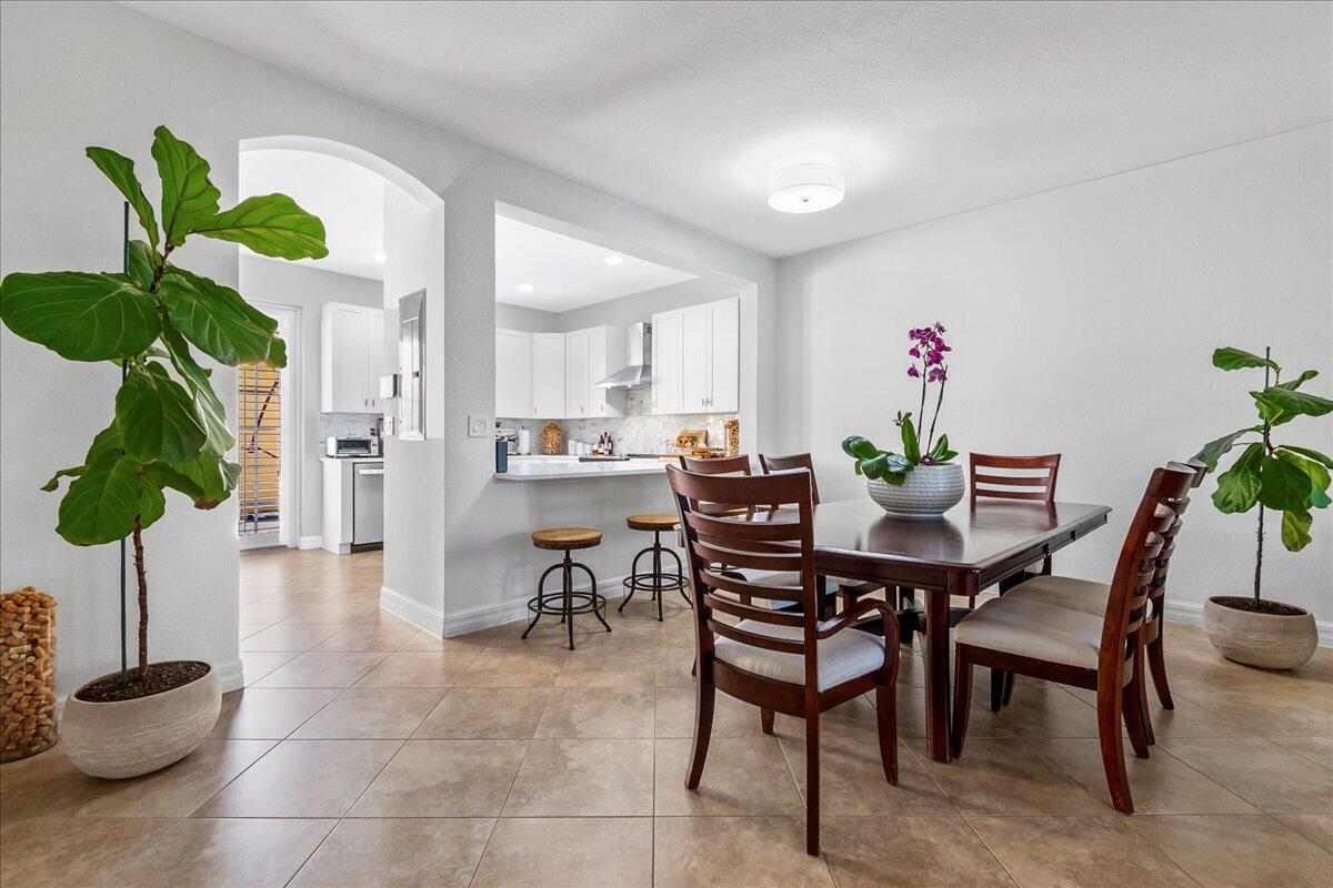 251 Edenberry Avenue Jupiter, FL 33458 - Photo 8 of 31 a dining room filled with furniture and a potted plant