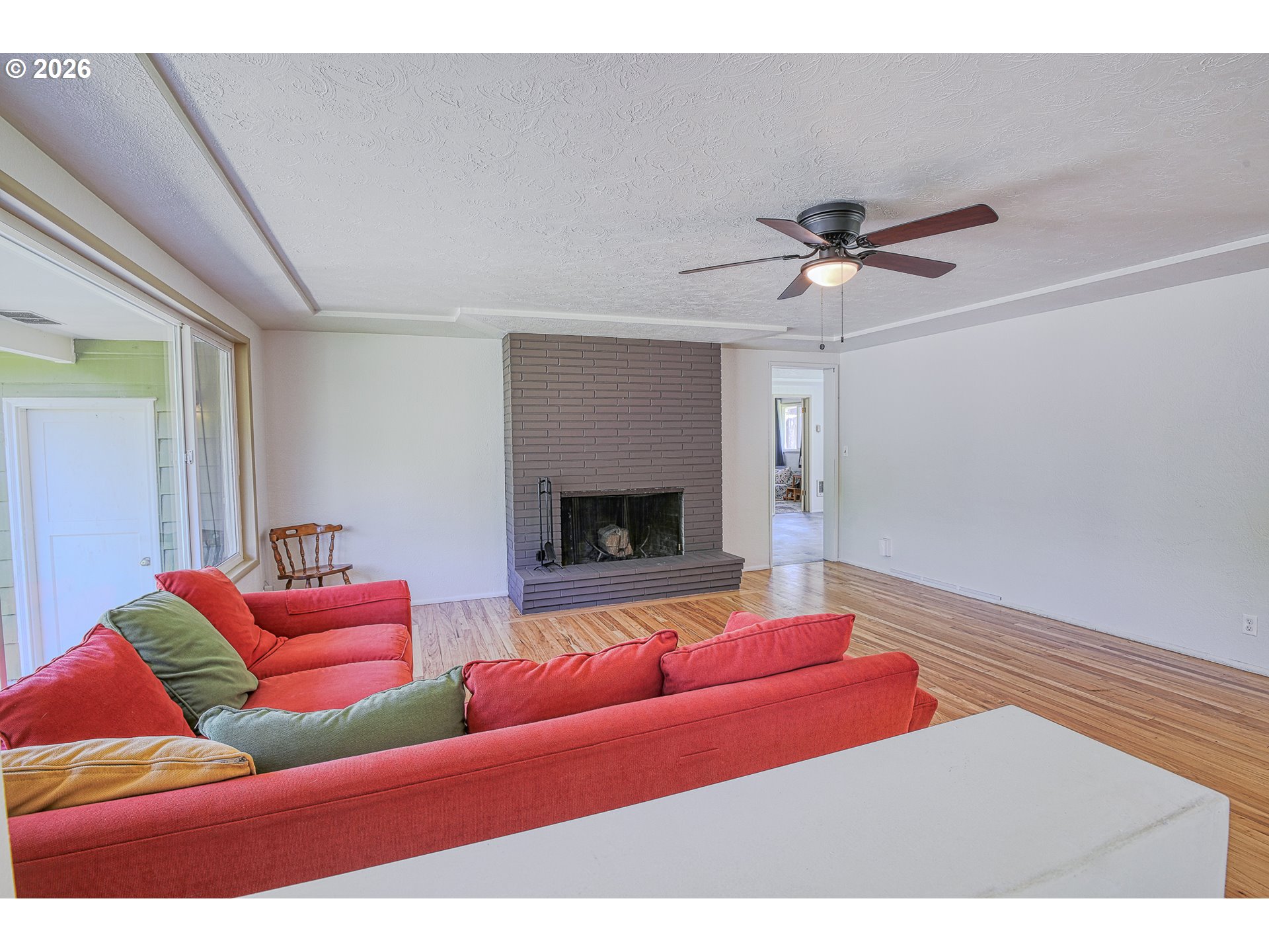 7077 Main Street Springfield, OR 97478 - Photo 4 of 34 a living room with furniture and a fireplace
