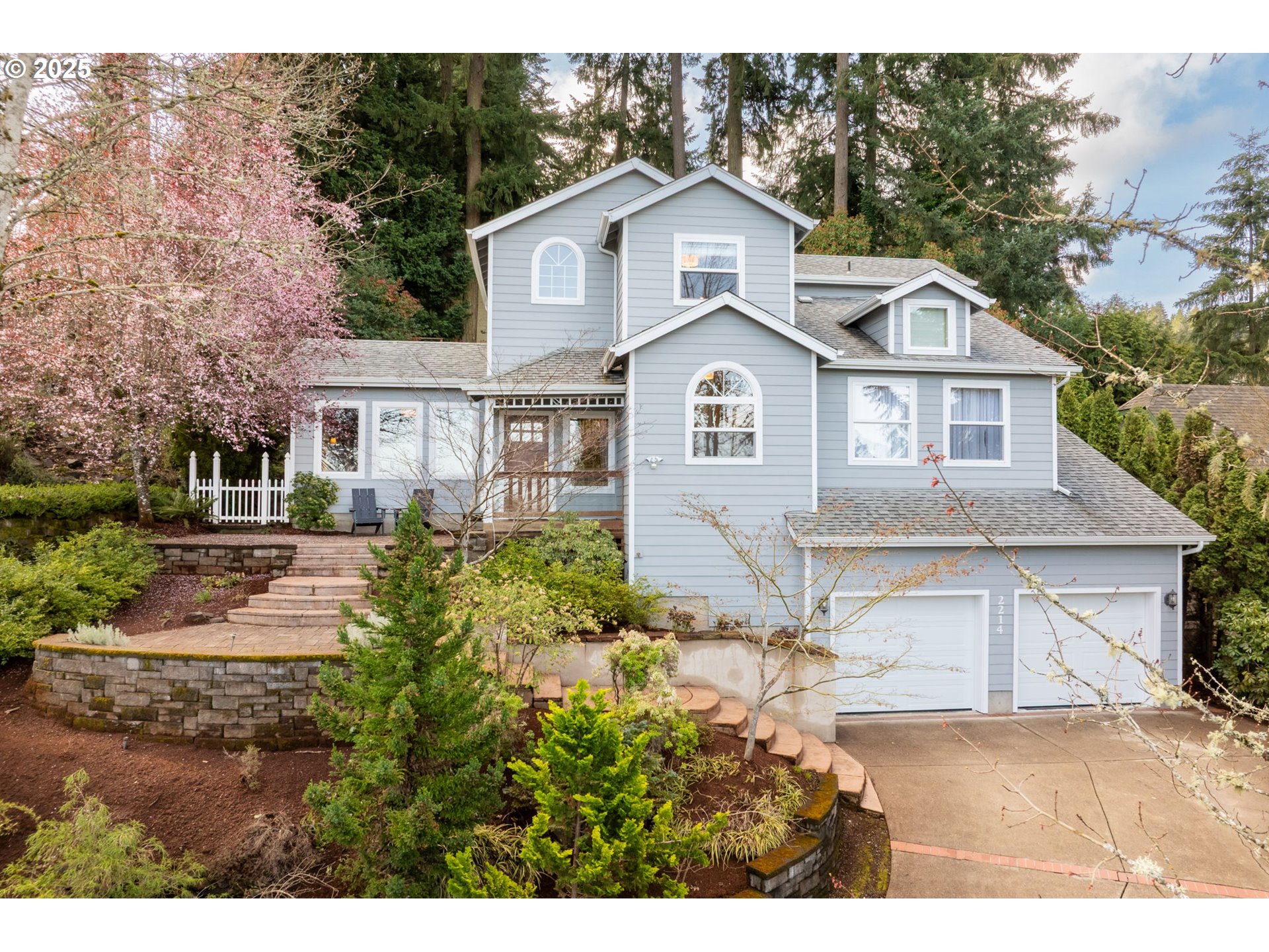 2214 West 25th Place Eugene, OR 97405 - Photo 1 of 48 a front view of a house with a yard and garage