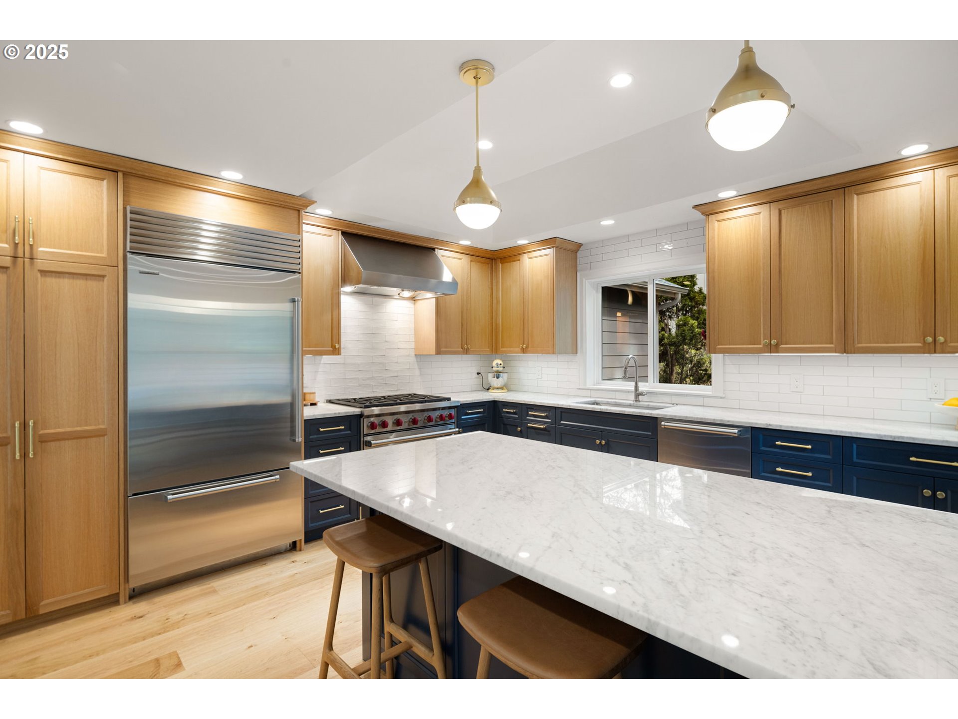 2214 West 25th Place Eugene, OR 97405 - Photo 14 of 48 a large kitchen with a center island wooden floor and stainless steel appliances