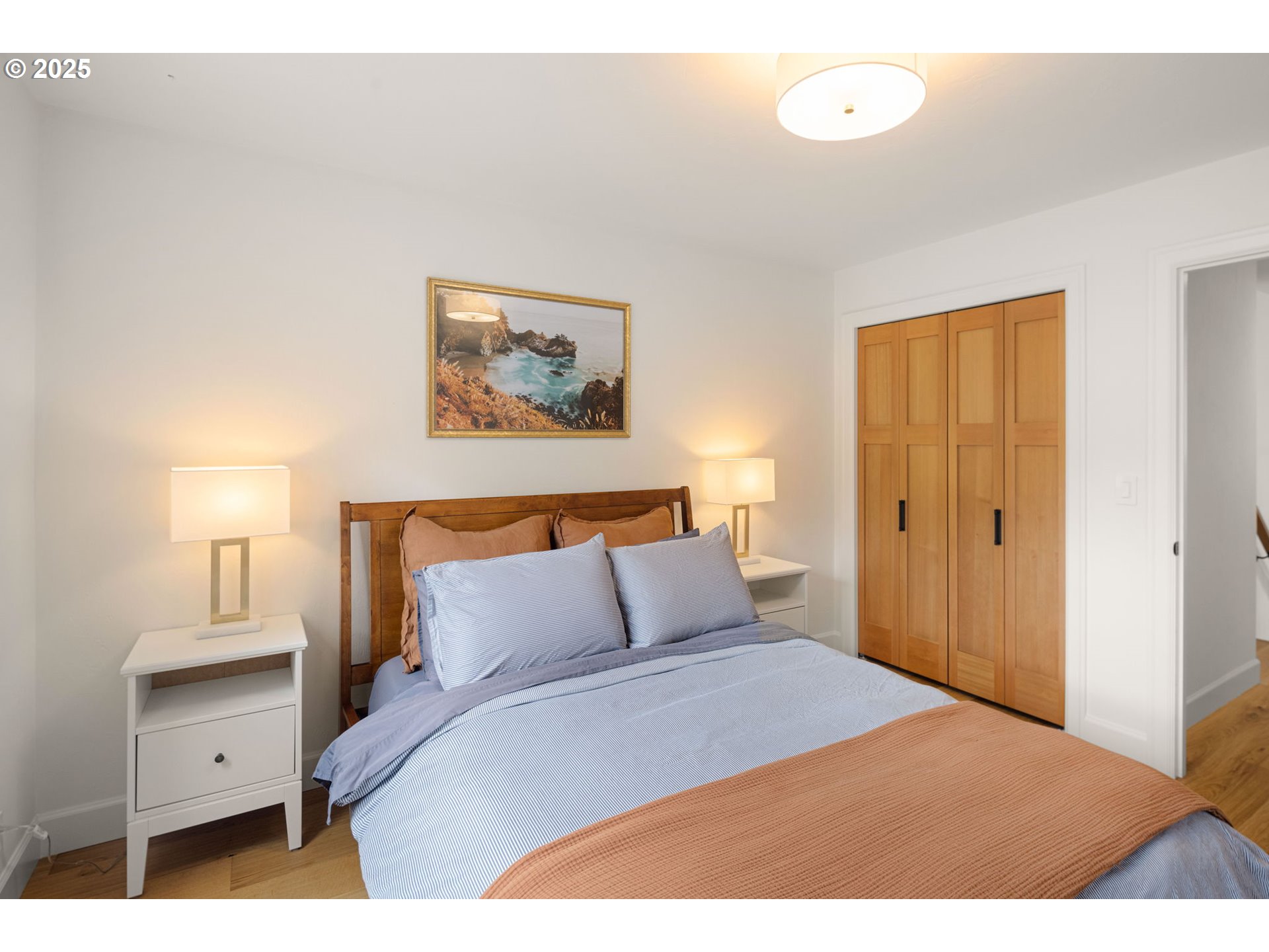 2214 West 25th Place Eugene, OR 97405 - Photo 36 of 48 a bedroom with a bed and a painting on the wall