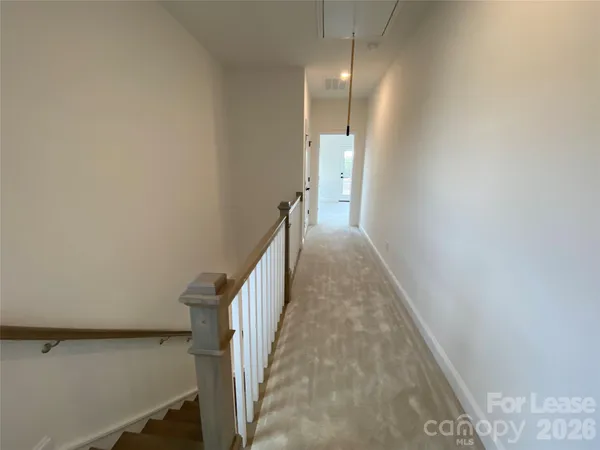 a view of a hallway with stairs
