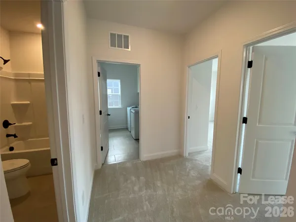 a view of a bathroom from a hallway
