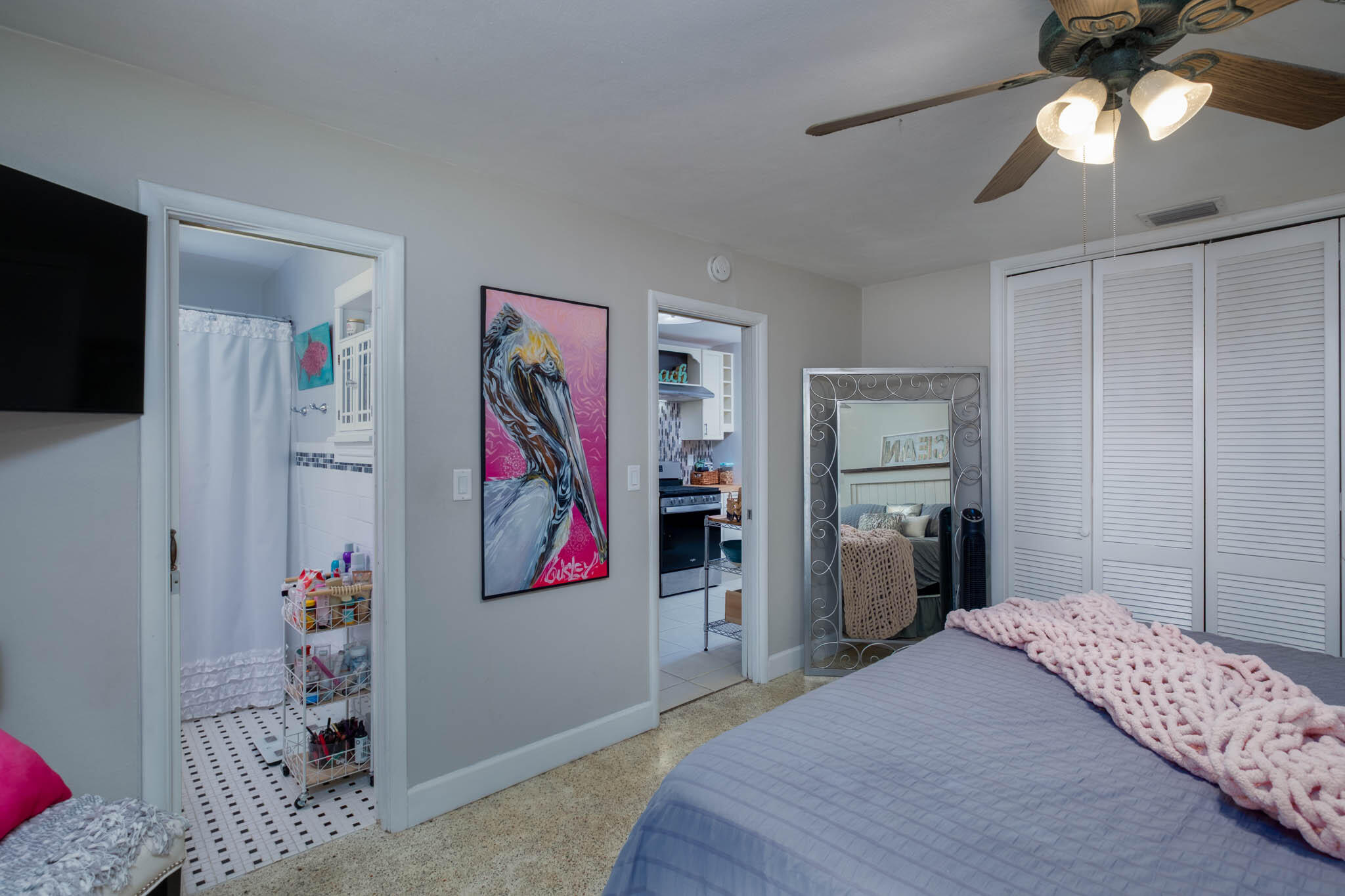 153 Apache Street Tavernier, FL 33070 - Photo 12 of 20 a bedroom with a bed and a chandelier