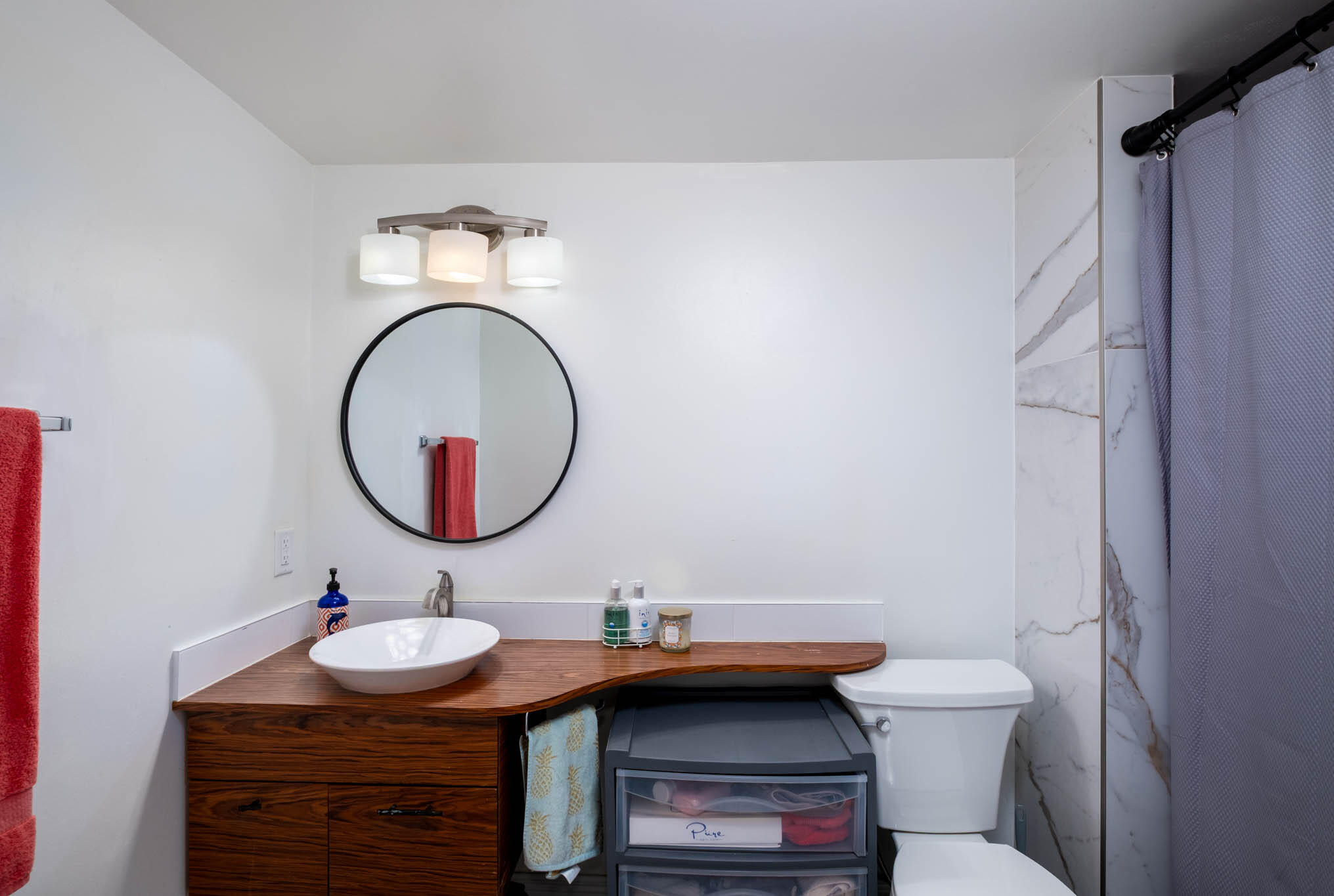 153 Apache Street Tavernier, FL 33070 - Photo 16 of 20 a bathroom with a sink a toilet and a mirror