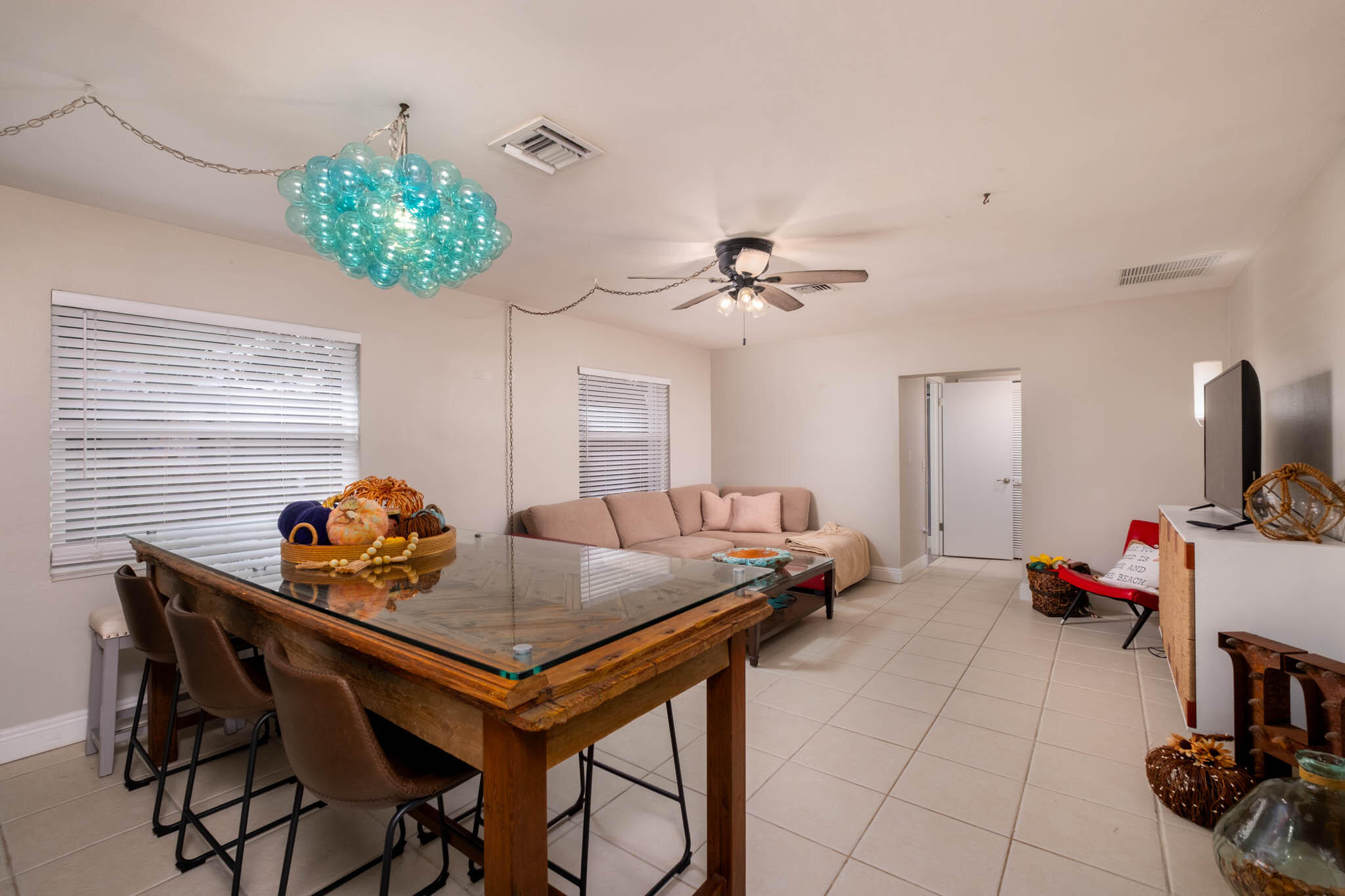 153 Apache Street Tavernier, FL 33070 - Photo 3 of 20 a room with furniture and a chandelier