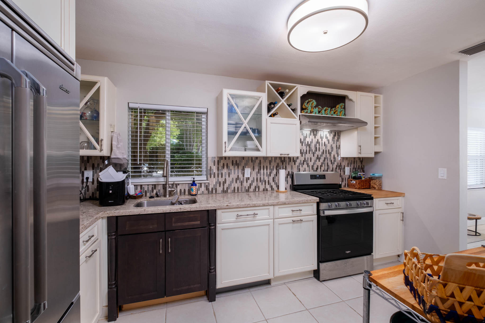 153 Apache Street Tavernier, FL 33070 - Photo 8 of 20 a kitchen with a sink stove and cabinets