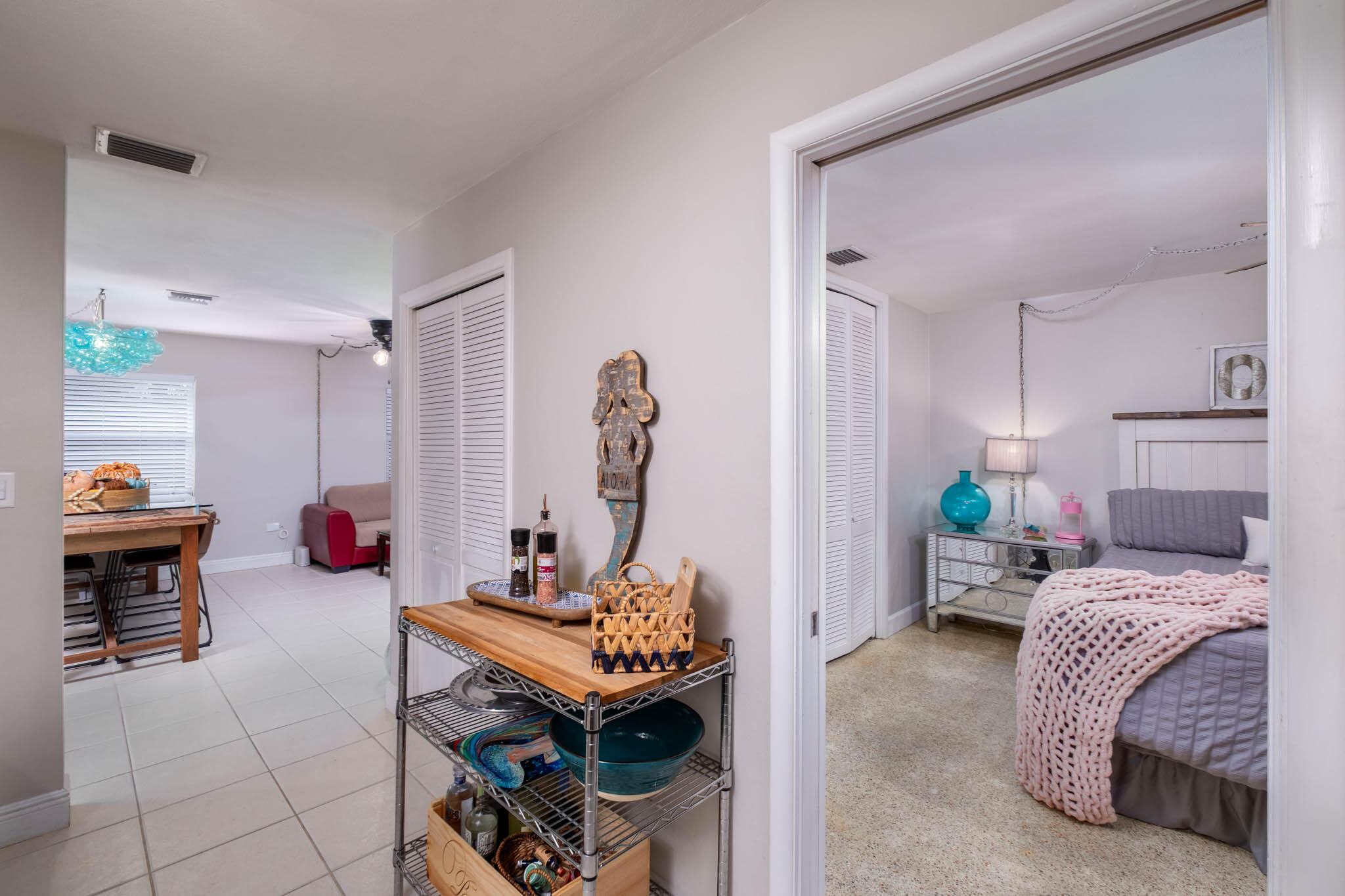 153 Apache Street Tavernier, FL 33070 - Photo 10 of 20 a bedroom with bed and a chandelier