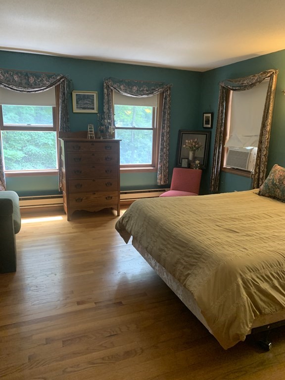 33 North Monson Road Hampden, MA 01036 - Photo 7 of 9 a bedroom with a bed a dresser next to a window