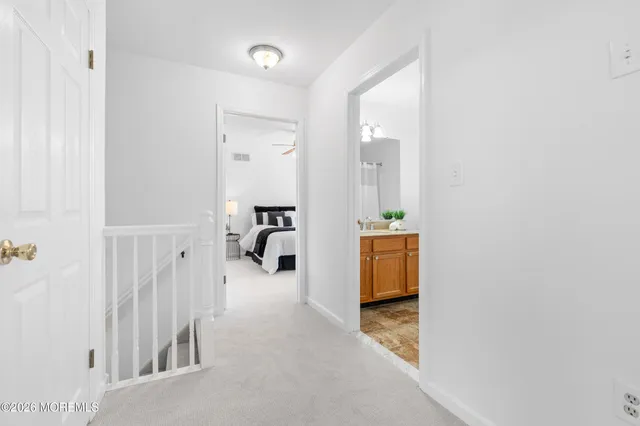 a hallway with a couch and a dining table