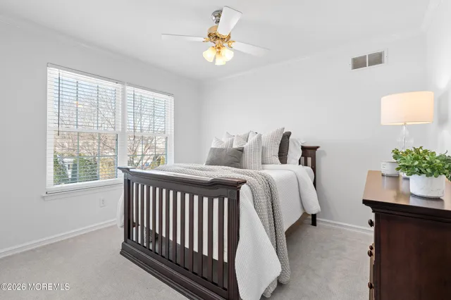 a bedroom with a bed and a potted plant