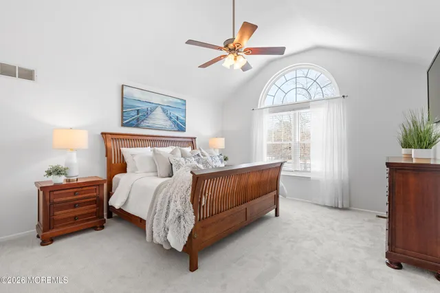 a bed room with a bed and a chandelier
