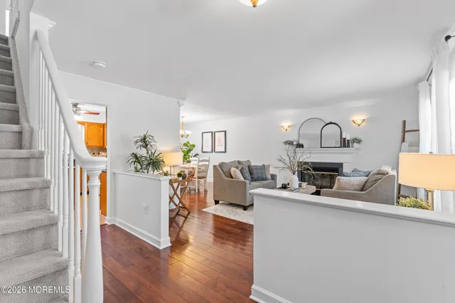 a living room with kitchen furniture and a wooden floor