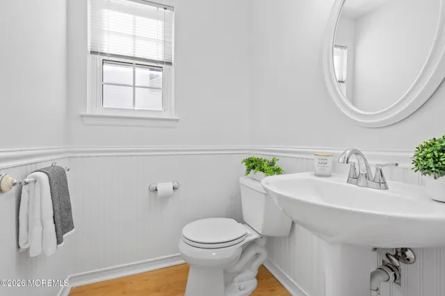 a bathroom with a sink mirror and toilet