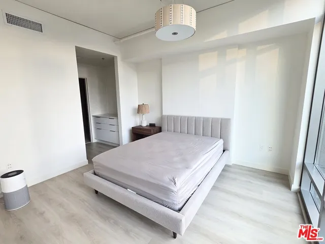 a bedroom with a bed and a mirror