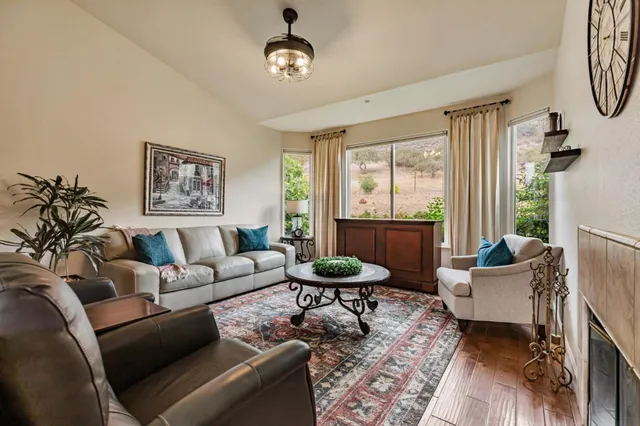 a kitchen with a stove a refrigerator a oven and a dining table with wooden floor