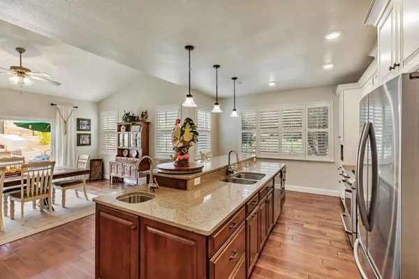 a kitchen with granite countertop a stove and a sink