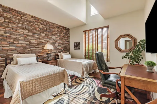 a bedroom with a bed and a flat screen tv
