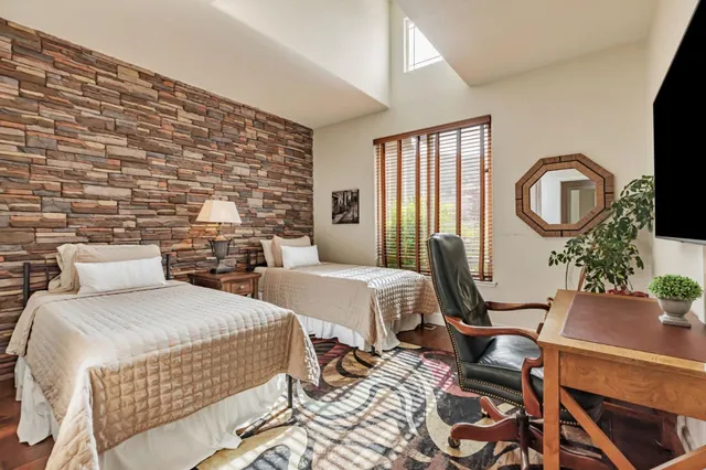 a bedroom with a bed and a flat screen tv